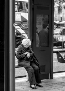older woman sitting on a bench